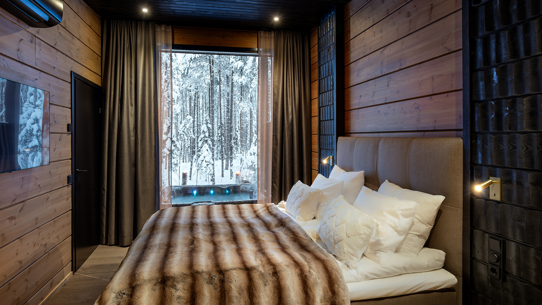 Romantic master bedroom with a forest view. | Lapland Luxury