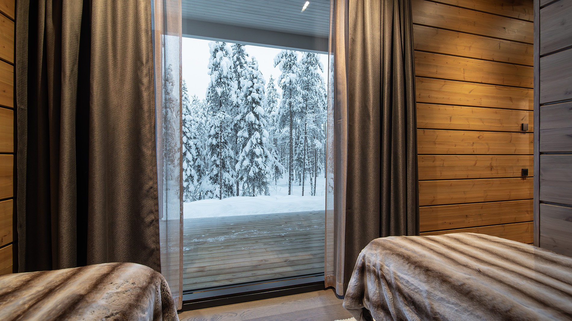 Forest view from the bedroom in luxurious villa. | Lapland Luxury