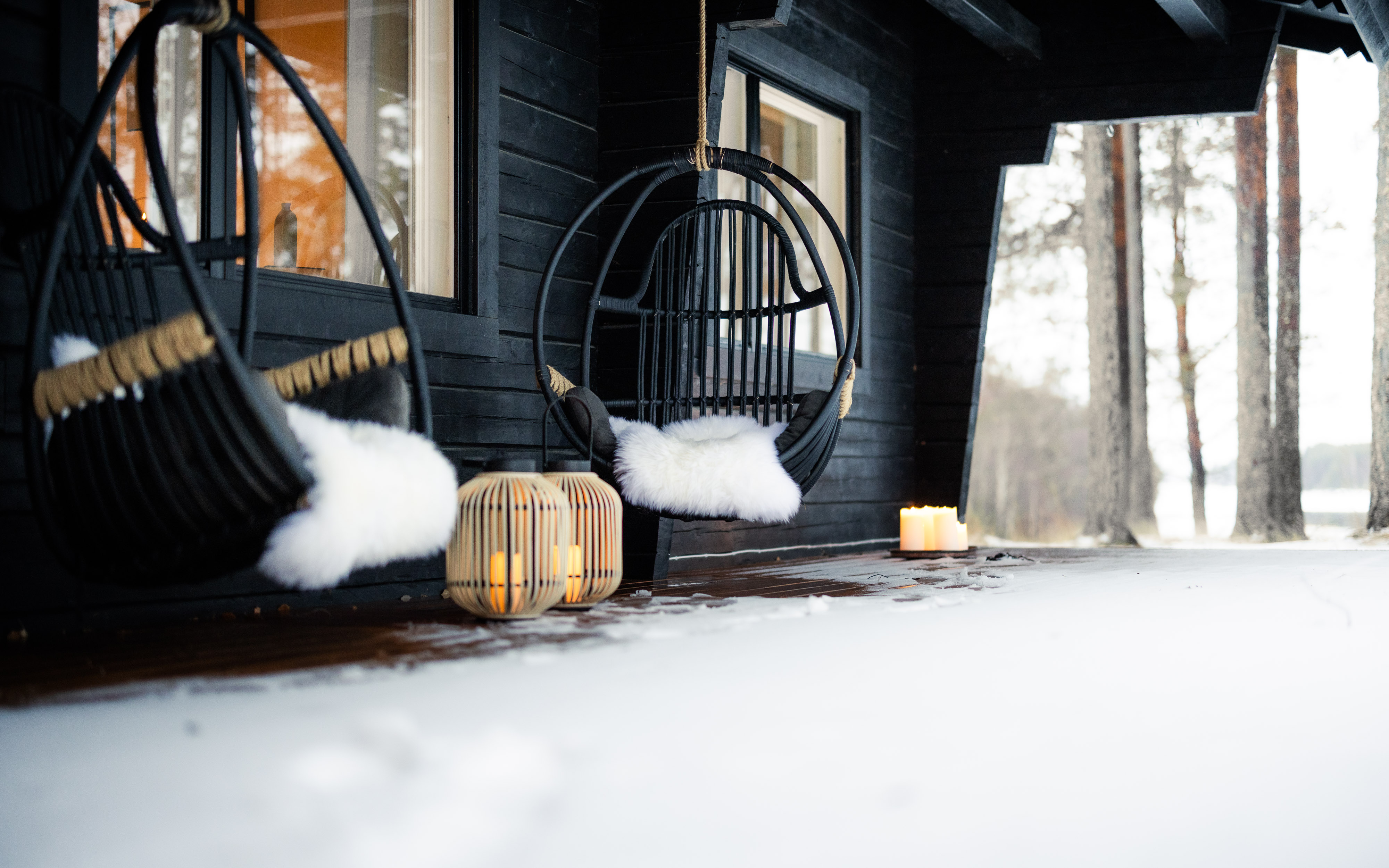 Comfortable outdoor terrace of a private villa with snow. Lapland Luxury.